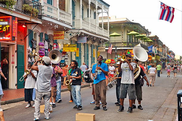 Jazz band performing live on Bourbon Street with musicians playing trumpet, saxophone, and drums.