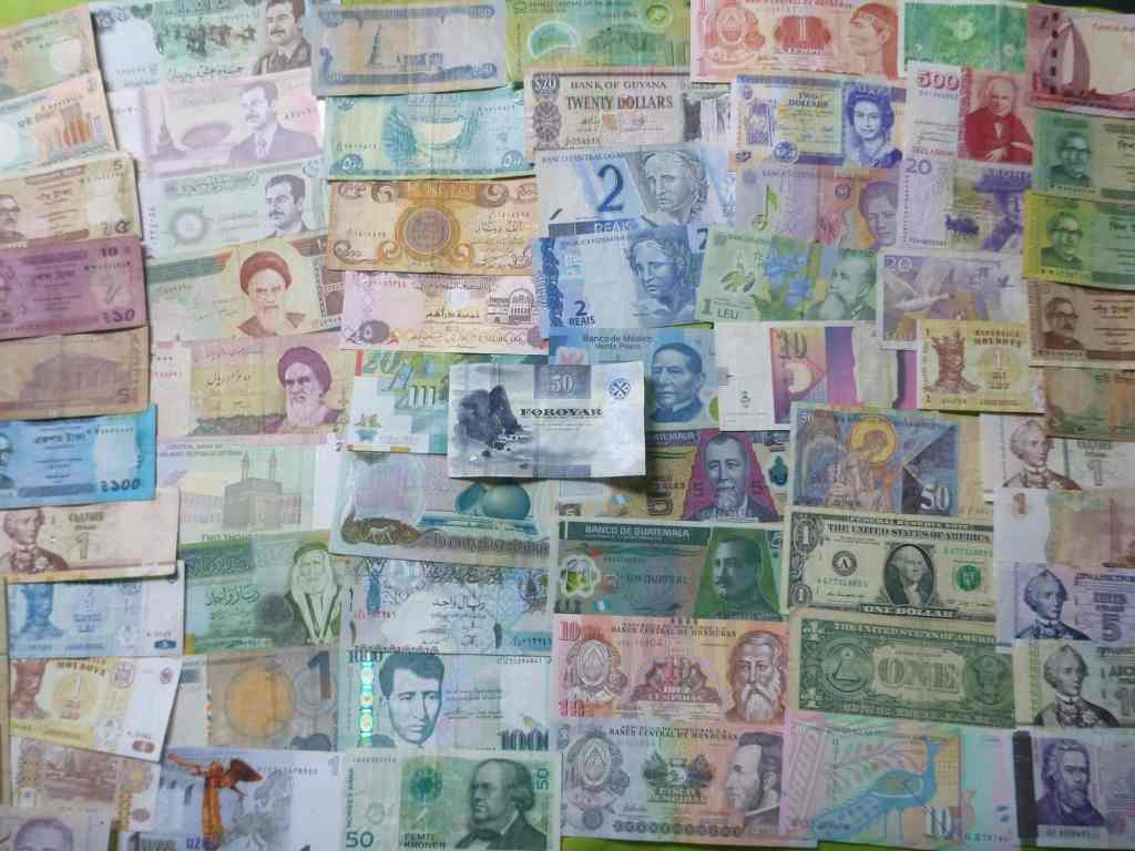 Stack of colorful international currency notes as travel souvenirs