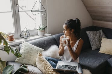 Millennial traveler budgeting and planning a trip from home